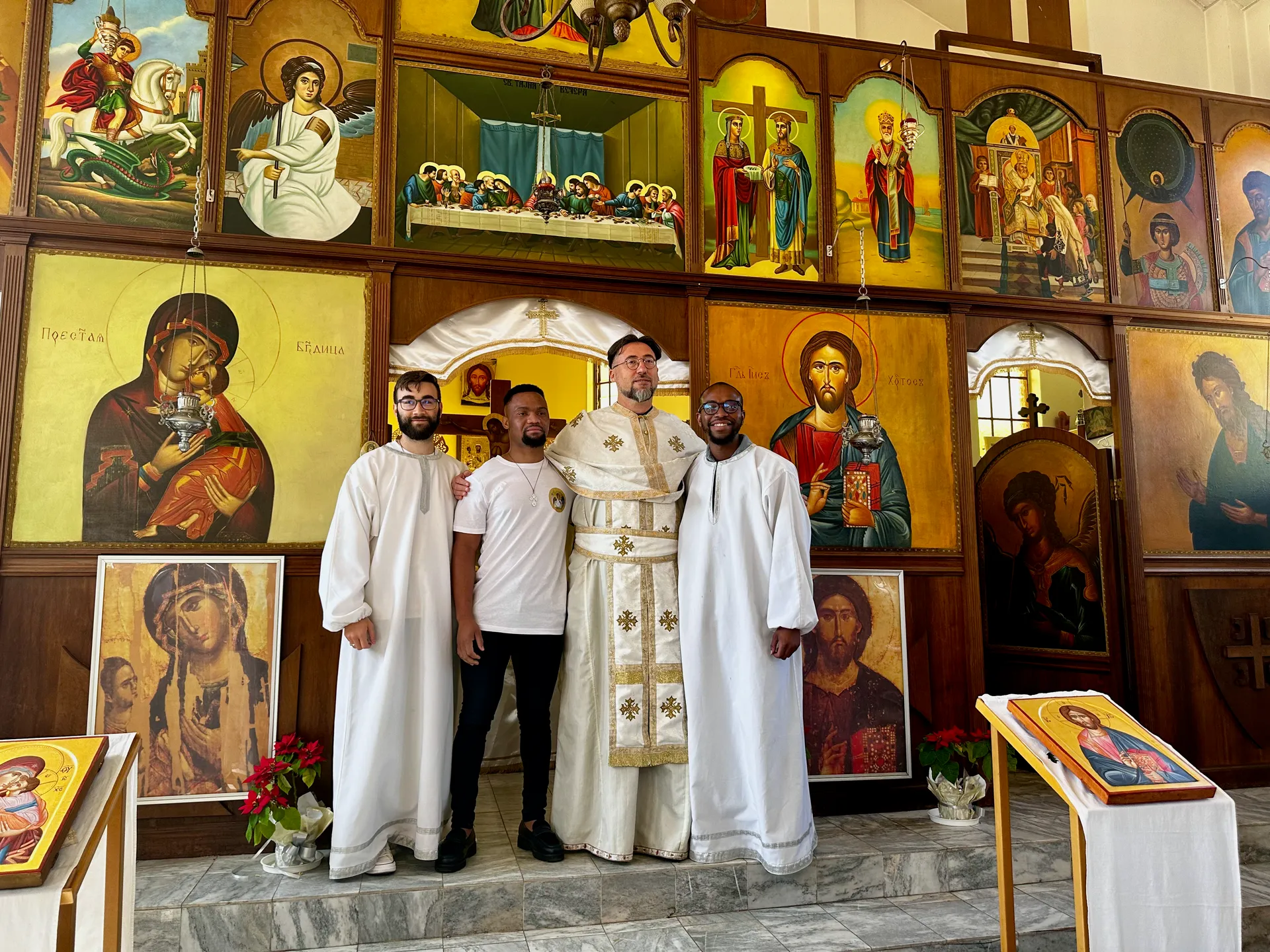 A newly baptized parishioner with Father Isajlo and altar servers before the iconostasis at St Thomas Serbian Orthodox Church