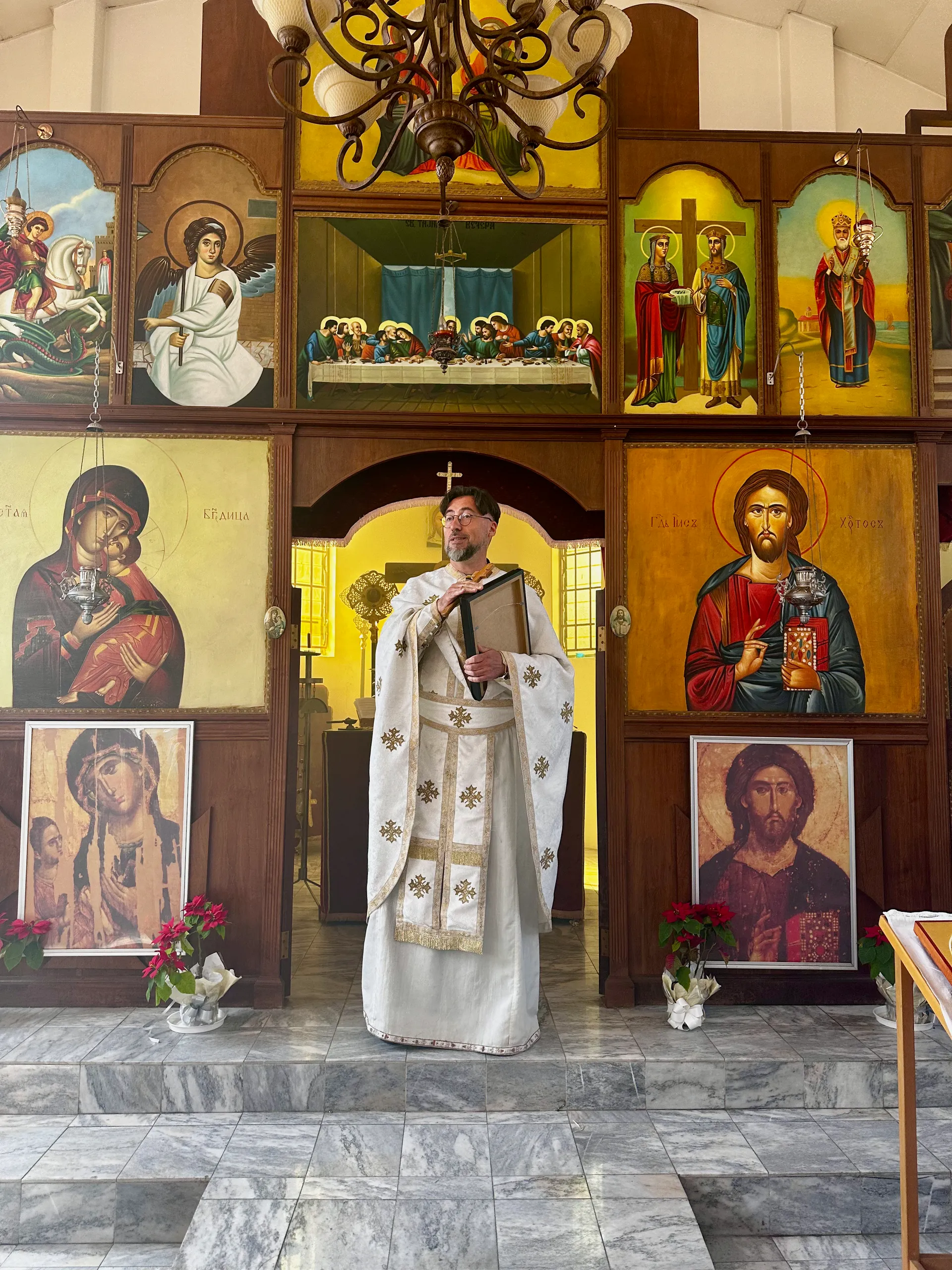 Father Isajlo standing before the icons during Divine Liturgy