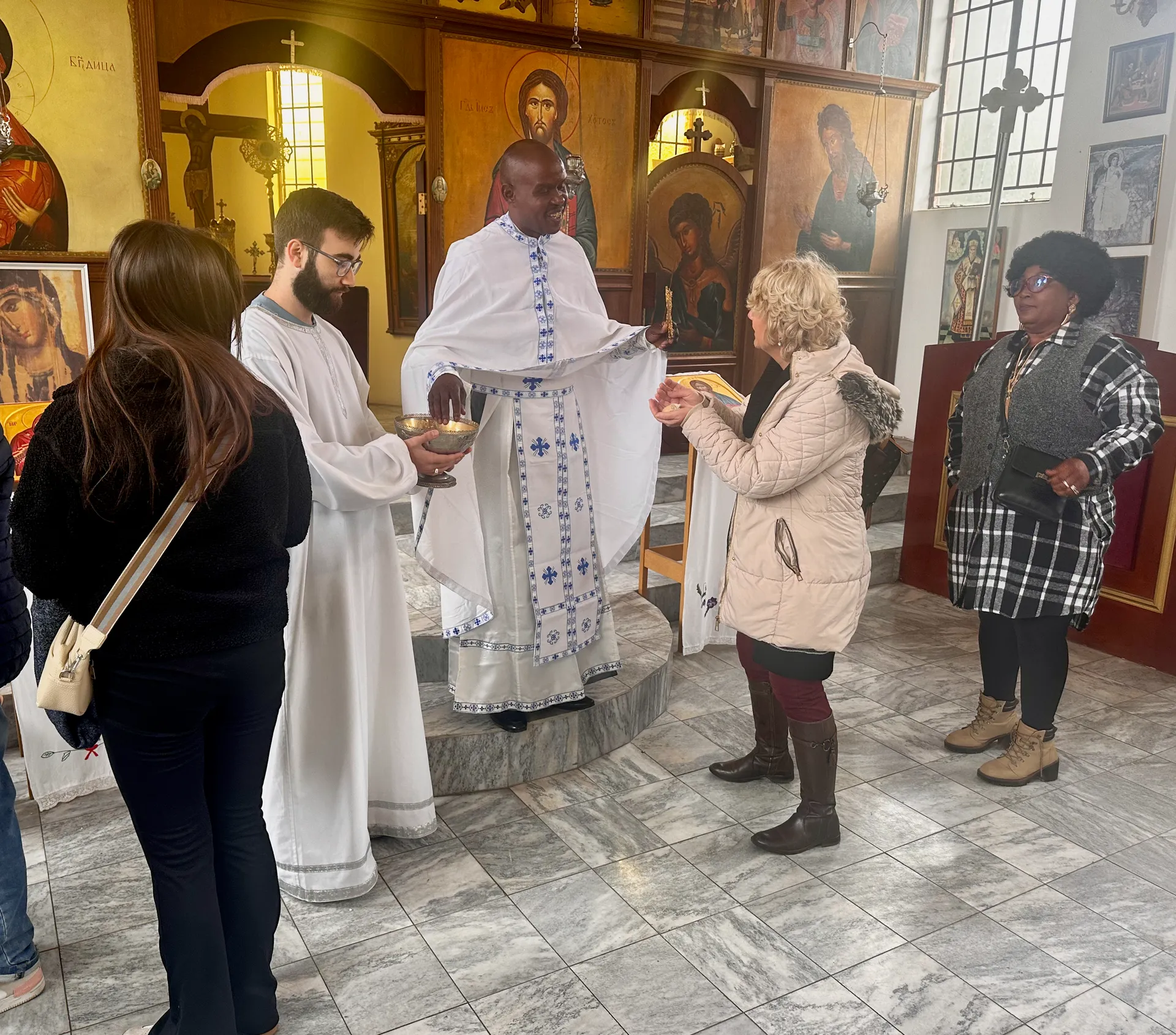 Father Markos distributing antidor (blessed bread) after the Divine Liturgy.
