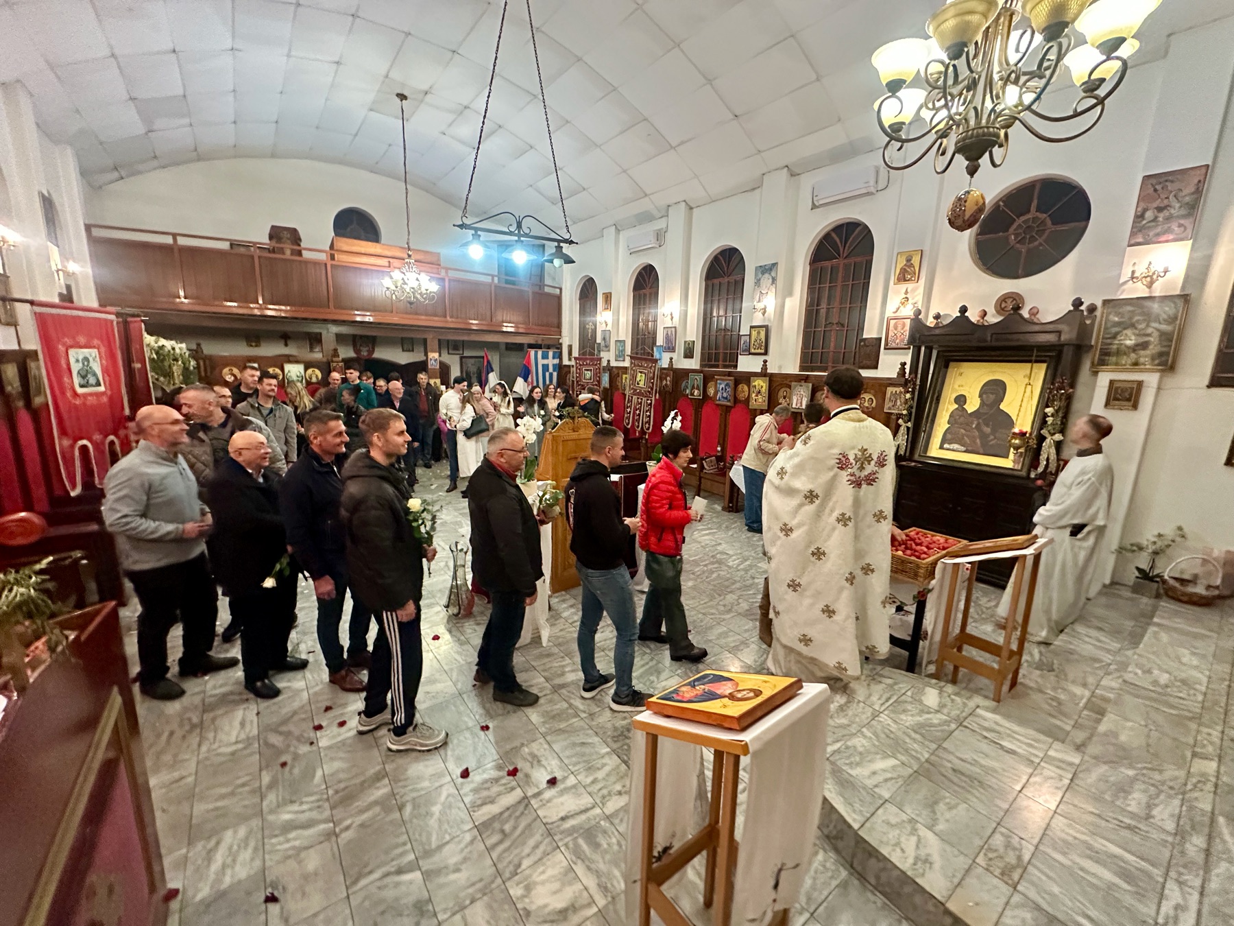 Paschal night procession with candles and faithful outside the church