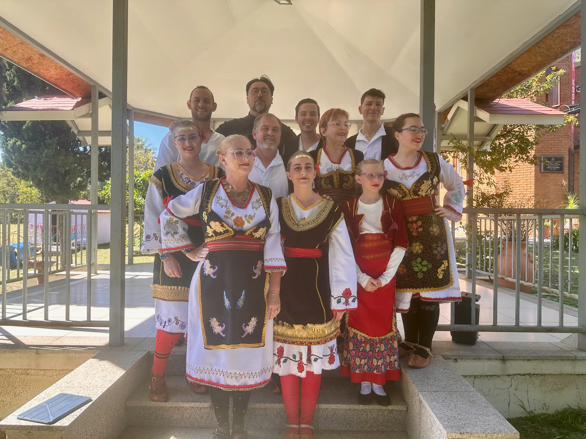 Young parishioners in traditional Serbian attire performing a cultural dance.