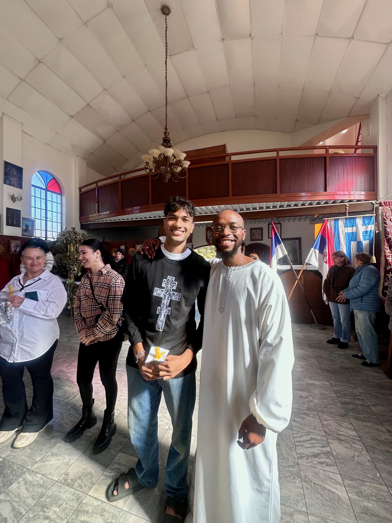 A family and godfather smiling after a baptism ceremony