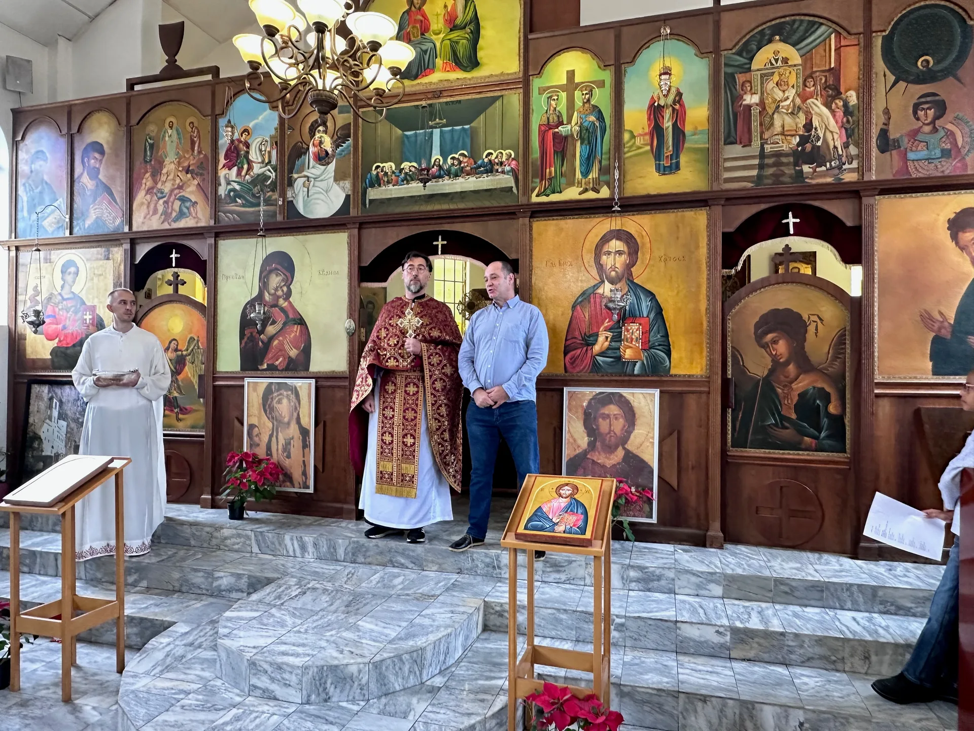 Clergy and parishioners standing before the iconostasis at St Thomas Serbian Orthodox Church