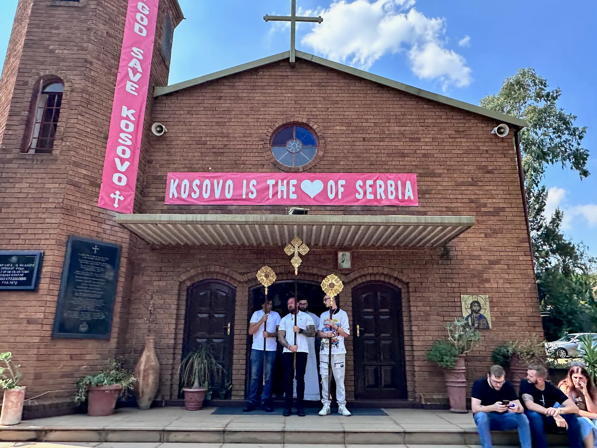 Parishioners carrying processional crosses outside St Thomas Serbian Orthodox Church on Palm Sunday