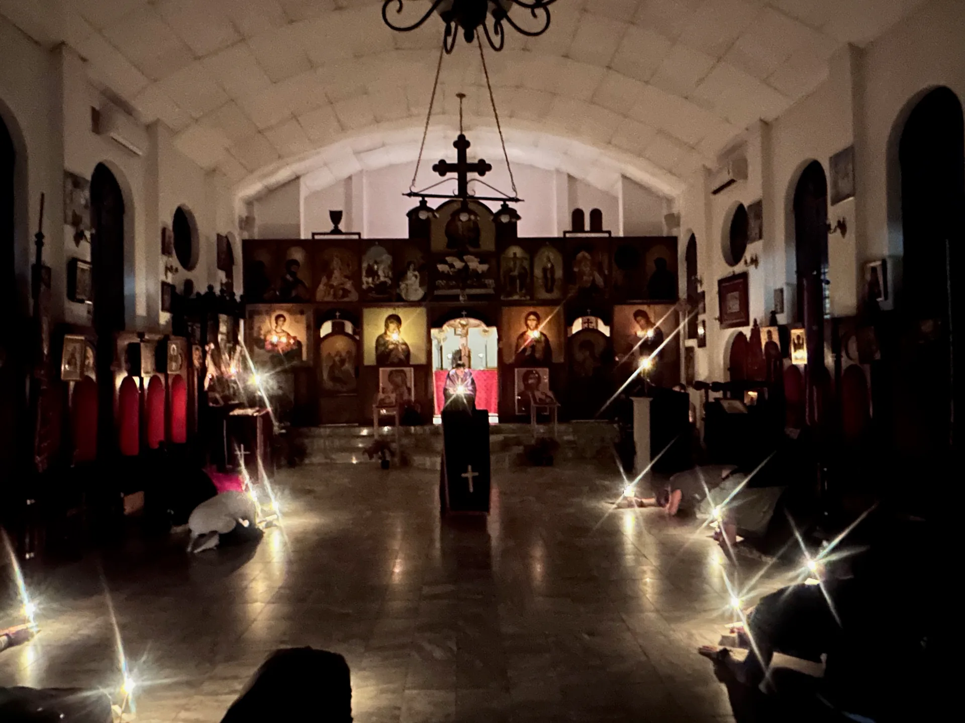 The church illuminated by candles during the Service of the Twelve Passion Gospels on Great and Holy Thursday