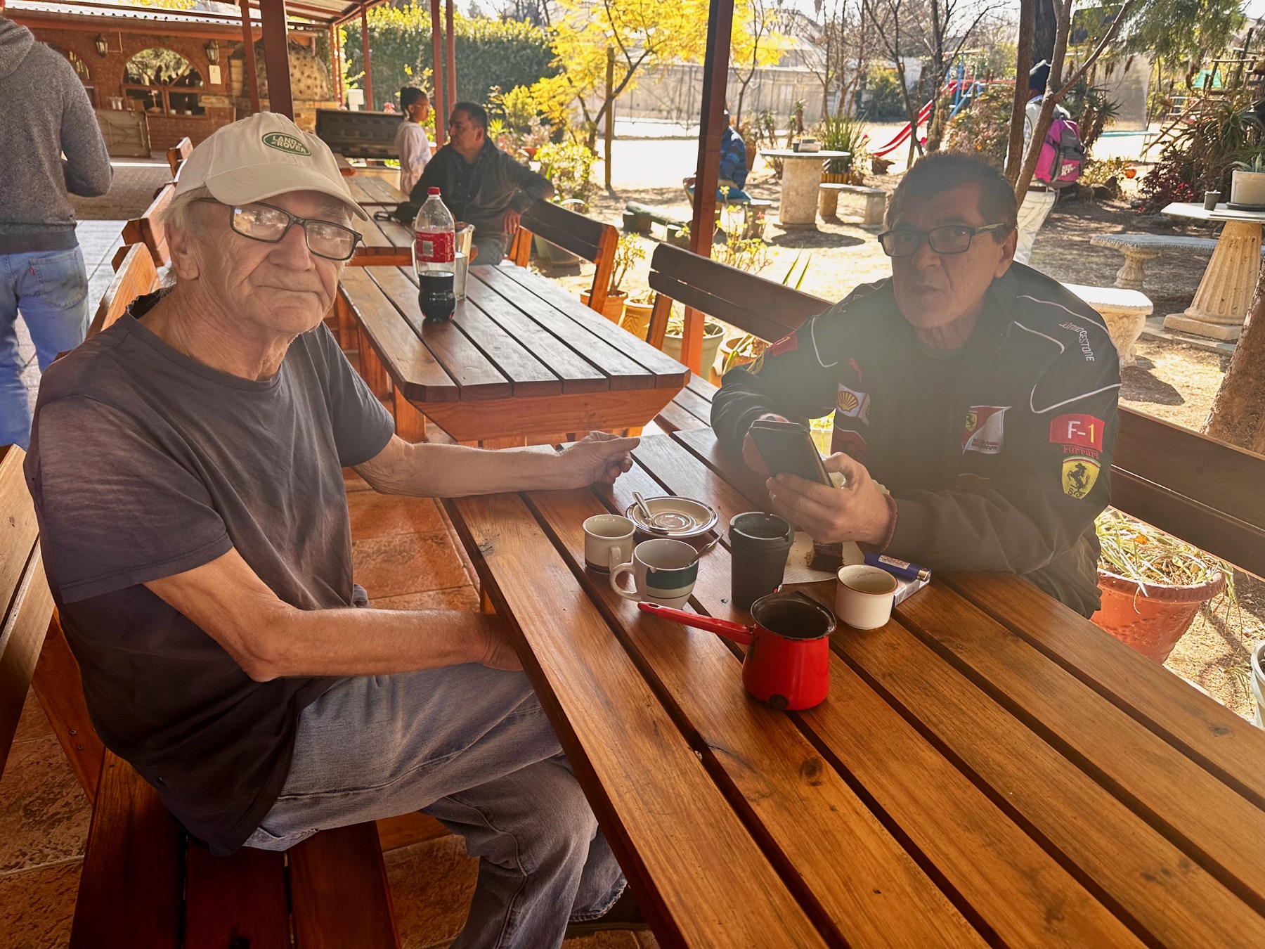 People enjoying coffee and conversation in the church garden after service
