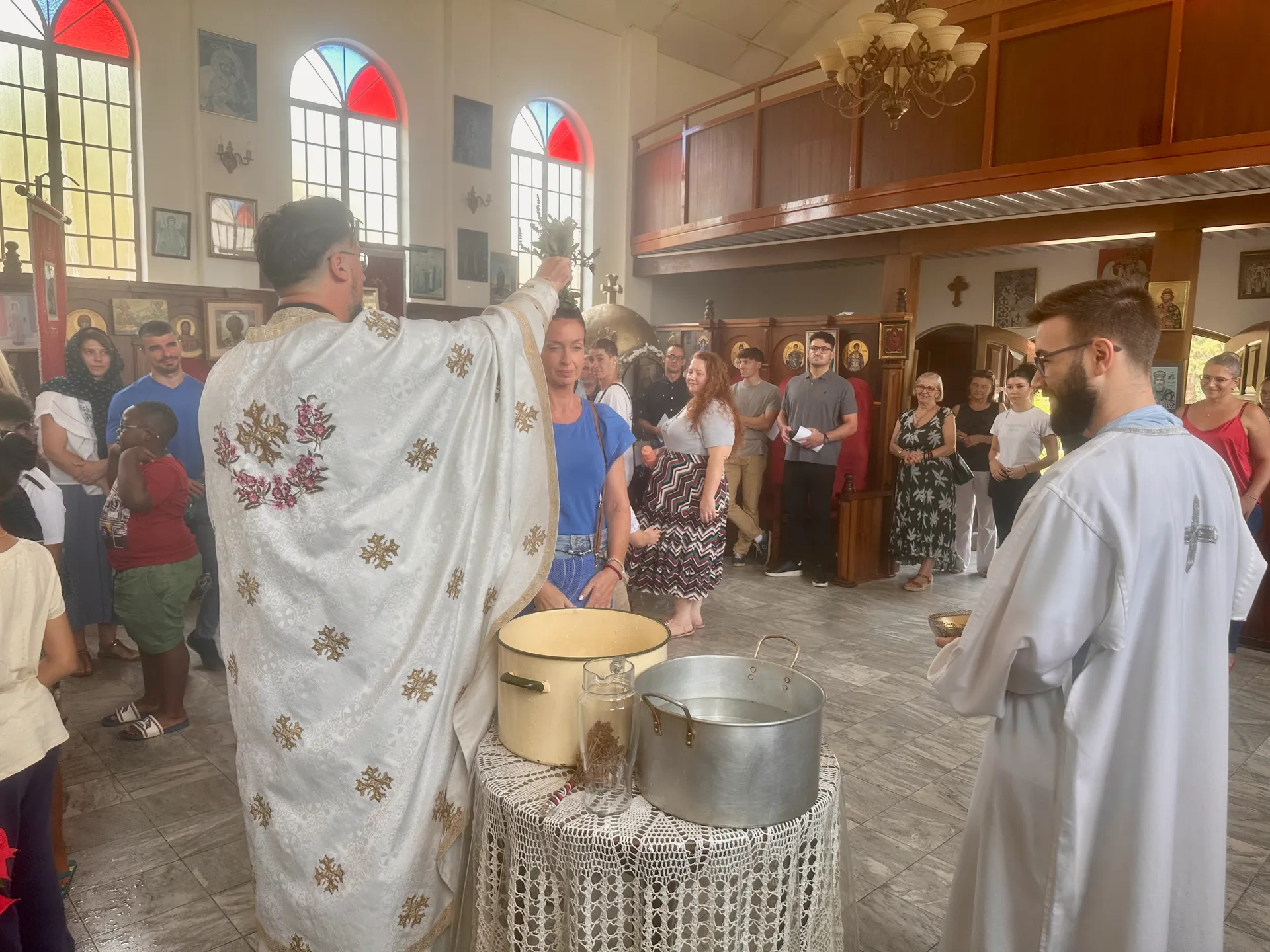 A priest blessing the congregation with holy water during the Divine Liturgy.