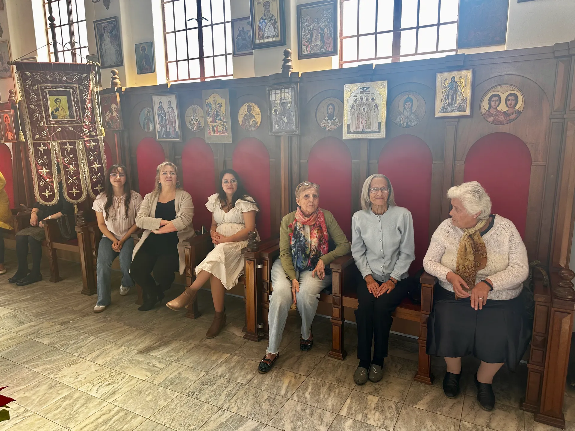 Parishioners sitting and listening to the sermon during Divine Liturgy.