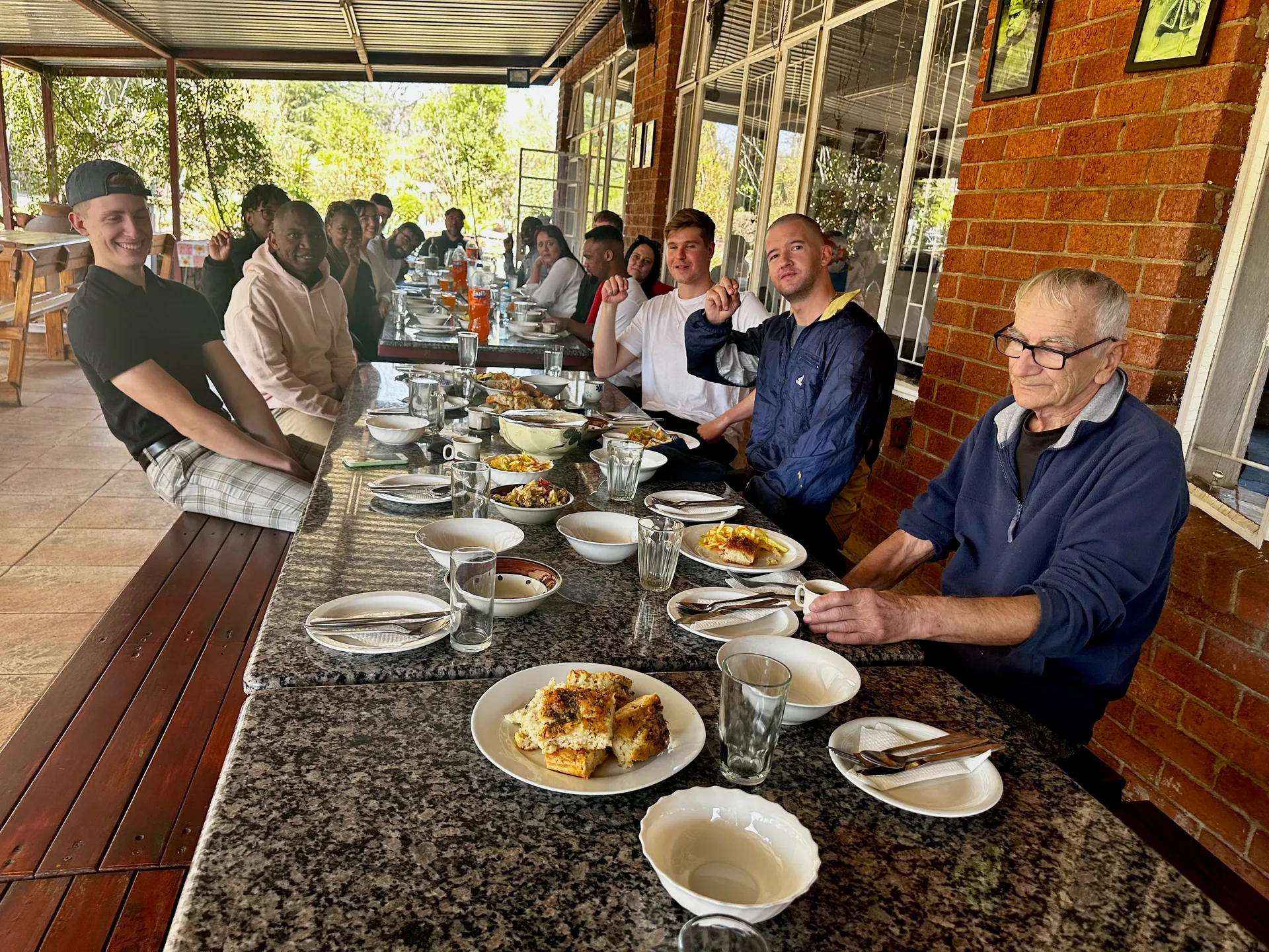 Parishioners enjoying a community lunch outdoors after the service.